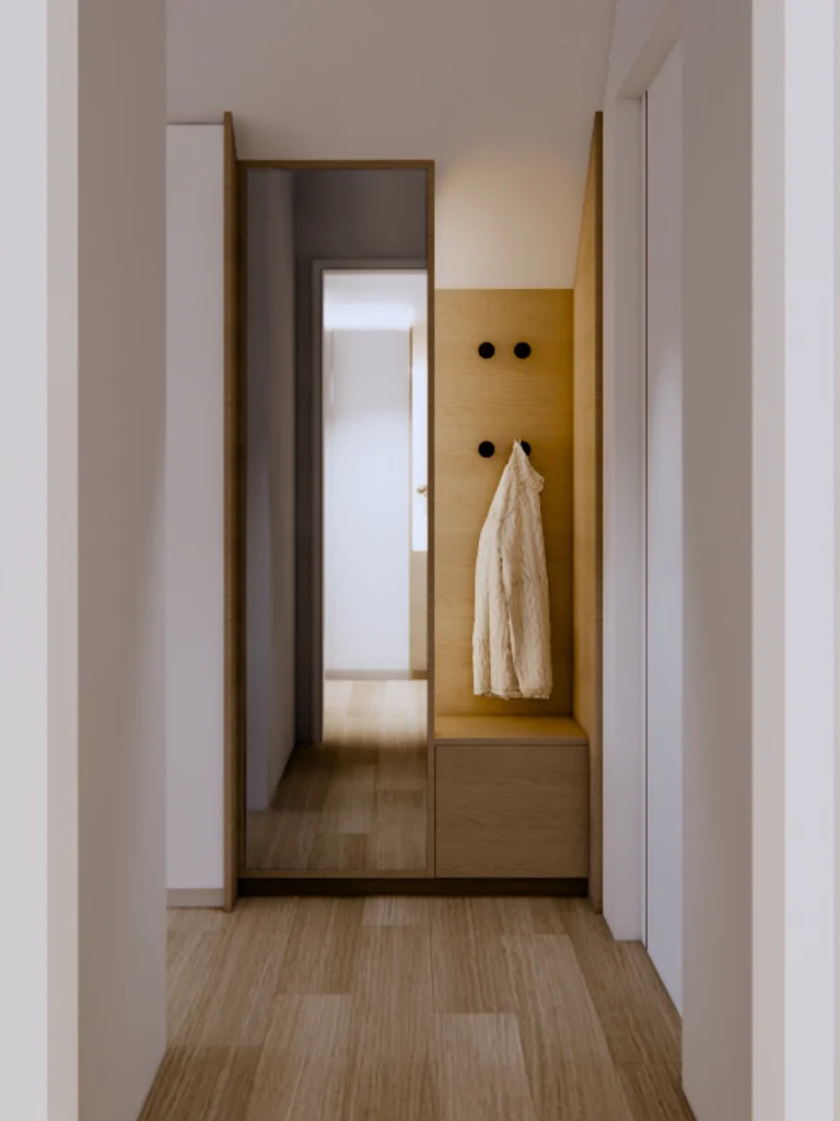 Hodnik z ogledalom po meri, lesenimi detajli in minimalistično garderobno nišo.